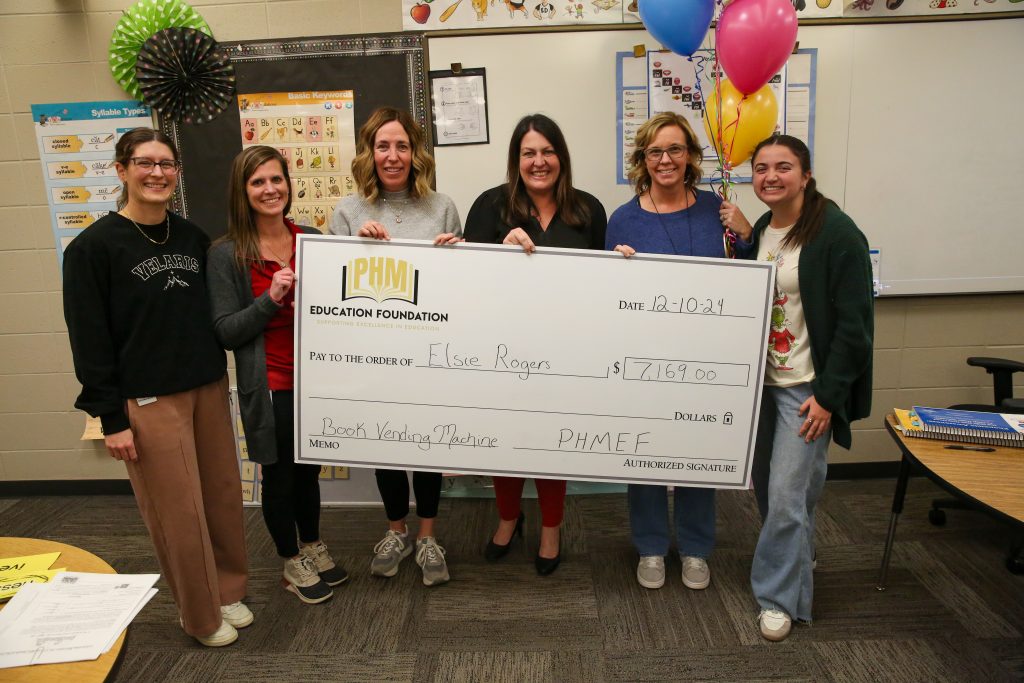 Teachers posing with checks