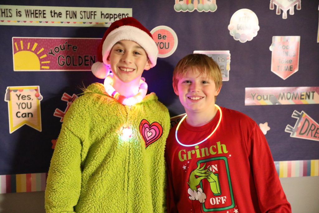 Two male students dressed in festive holiday clothes