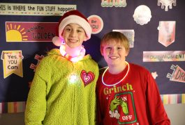Two male students dressed in festive holiday clothes
