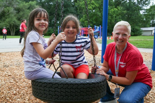 Students on playground with teacher