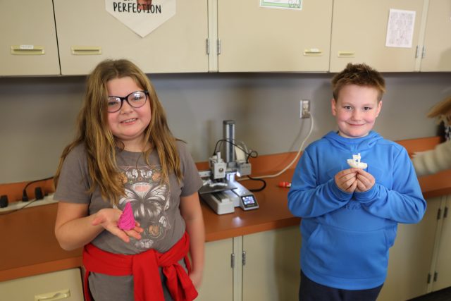 students playing with fidget tools in front of 3D printer