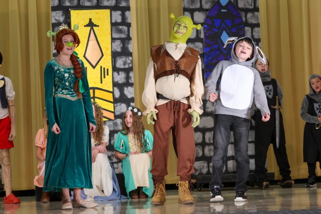 students performing in Shrek the Musical