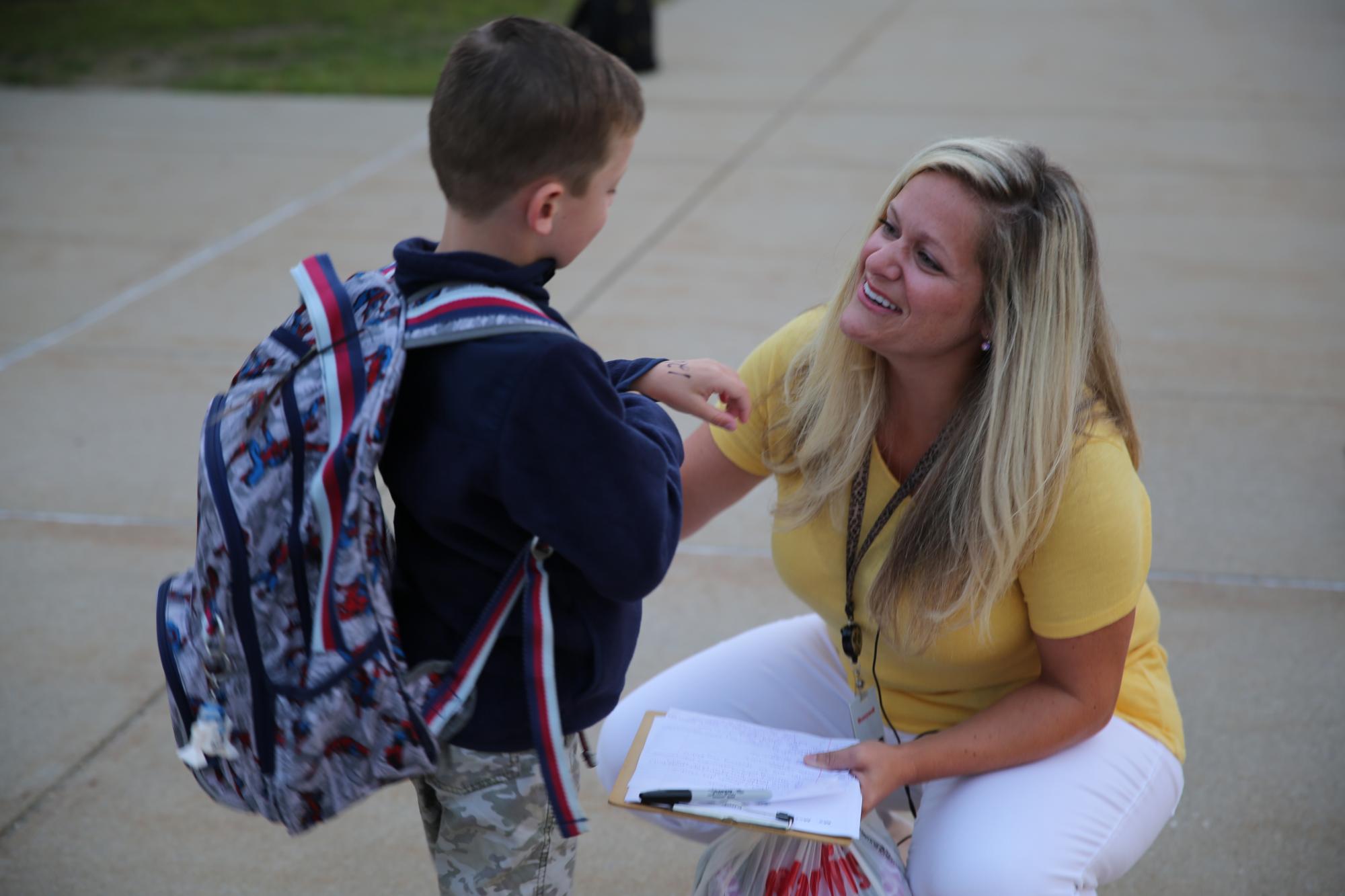 Mrs. McCambridge greets Northpoint kindergartners on the 1st Day of Kindergarten